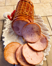 Load image into Gallery viewer, Only the finest hams are select for this special treat. This ham is honey glazed on all sides and injected inside to ensure that every bite has the sweet taste of honey. This ham is boneless and sliced. This ham is fully cooked and ready to heat and serve.