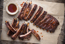 Load image into Gallery viewer, Rubbed with our secret spices and slow-smoked over real hickory. Fully cooked. Ready to thaw, and heat in the oven or on the grill.
