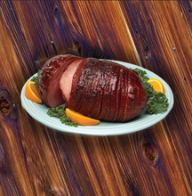Load image into Gallery viewer, Only the finest hams are select for this special treat. This ham is honey glazed on all sides and injected inside to ensure that every bite has the sweet taste of honey. This ham is boneless and sliced. This ham is fully cooked and ready to heat and serve.