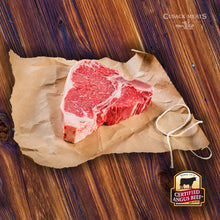 Load image into Gallery viewer, This delicious Certified Angus Beef ® steak features both the New York Strip AND the Tenderloin Filet - what more could you ask for? The Porterhouse is distinguishable from the T-Bone by having a larger portion of Tenderloin Filet. These delicious steaks are 1 1/4 lbs. each and will satisfy even the heartiest of appetites!