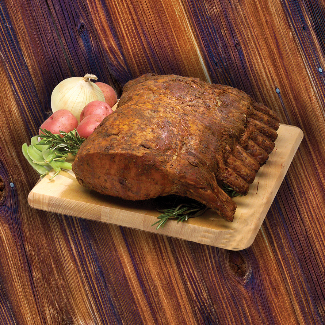 Hickory Smoked Rack of Pork with wood background. This product is fully cooked. Just heat and eat.